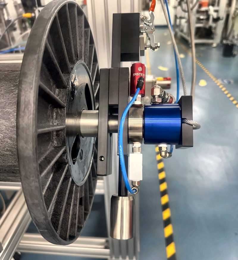 Large reel mounted on a machined shaft with a rotary union and air fittings